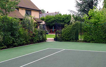 Landscaped home tennis court built by Anglia & Midlands Sports - AMSS