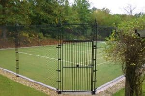 Artificial grass tennis court built by AMSS using Sporturf